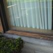 A peeling window sill brought down to bare wood